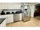 This kitchen features stainless steel appliances, white cabinets and a dishwasher at 3752 Fox Dale Ln, Holiday, FL 34691