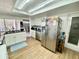 This kitchen features stainless steel appliances, white cabinets, granite counter tops, and a view to the dining room at 3752 Fox Dale Ln, Holiday, FL 34691
