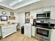 Bright kitchen with stainless steel appliances, granite counter tops, ample storage, and a view of the backyard at 3752 Fox Dale Ln, Holiday, FL 34691