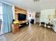 Bright living room with wood flooring, accent wall, and comfortable seating area at 3752 Fox Dale Ln, Holiday, FL 34691