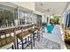This home has a spacious patio, complete with a bar area, seating, ceiling fans, and a beautiful patterned rug at 3752 Fox Dale Ln, Holiday, FL 34691