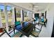 Covered patio with seating, outdoor kitchen, and ceiling fans at 3752 Fox Dale Ln, Holiday, FL 34691