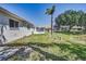 Beautiful backyard features a sunroom, well-maintained lawn, lush landscaping and pond views at 4030 Casa Del Sol Way, New Port Richey, FL 34655