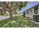 A large tree graces the backyard lawn providing ample shade near the waterfront at 4030 Casa Del Sol Way, New Port Richey, FL 34655