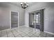 Open dining area features stylish chandelier and access to enclosed porch at 4030 Casa Del Sol Way, New Port Richey, FL 34655