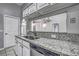 Kitchen sink and counter with granite countertops at 4030 Casa Del Sol Way, New Port Richey, FL 34655