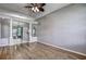 Bright living room showcasing wood floors, fan, and opening to dining room at 4030 Casa Del Sol Way, New Port Richey, FL 34655