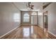 Spacious living room features wood floors, fan, and abundant natural light at 4030 Casa Del Sol Way, New Port Richey, FL 34655