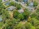 Expansive aerial view of a property surrounded by lush greenery, offering privacy and a tranquil setting at 446 Romine Ct, Spring Hill, FL 34609