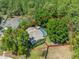 Aerial view of the property with mature trees providing privacy, highlighted by a screened pool and fenced yard at 446 Romine Ct, Spring Hill, FL 34609