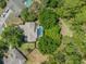 Aerial shot showcasing a backyard pool surrounded by lush greenery and neighboring properties at 446 Romine Ct, Spring Hill, FL 34609