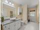 Bathroom with single sink, granite countertop, white cabinetry, and a walk-in shower at 446 Romine Ct, Spring Hill, FL 34609