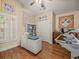 Bright bedroom with a vaulted ceiling, shuttered window, and wooden floors at 446 Romine Ct, Spring Hill, FL 34609