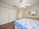 Comfortable bedroom with a ceiling fan, wood flooring, and a large closet at 446 Romine Ct, Spring Hill, FL 34609