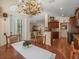 Open dining area adjacent to kitchen features a decorative chandelier and views of the living room at 446 Romine Ct, Spring Hill, FL 34609