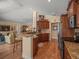 Open concept kitchen with granite countertops, wood cabinets, and stainless steel appliances at 446 Romine Ct, Spring Hill, FL 34609