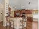 A charming kitchen features warm wood cabinetry, granite countertops, and stainless steel appliances at 446 Romine Ct, Spring Hill, FL 34609