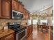Well-equipped kitchen featuring modern appliances, custom cabinets, and a cozy dining area at 446 Romine Ct, Spring Hill, FL 34609