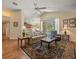 Open-concept living room with hardwood floors, a vaulted ceiling, and a view of the screened-in pool area at 446 Romine Ct, Spring Hill, FL 34609
