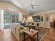 Cozy living room with plush sofa and view of the pool at 446 Romine Ct, Spring Hill, FL 34609