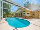 Beautiful screened-in pool area with an outdoor dining area, perfect for entertaining at 446 Romine Ct, Spring Hill, FL 34609