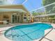 Inviting screened-in pool area featuring a sparkling blue pool and a covered patio at 446 Romine Ct, Spring Hill, FL 34609