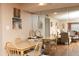 Inviting dining area with a wooden table and chairs, illuminated by a decorative light fixture and mirrored wall at 4726 Marine Pkwy # 201, New Port Richey, FL 34652