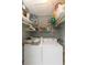 Functional laundry room with a washer, dryer, and ample shelving for storage and organizing at 4726 Marine Pkwy # 201, New Port Richey, FL 34652