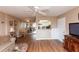 Comfortable living room featuring wood floors and a cozy seating area connected to the kitchen and dining space at 4726 Marine Pkwy # 201, New Port Richey, FL 34652