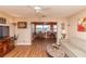 Cozy living room featuring wood floors and a comfortable seating area, adjacent to the dining area and TV at 4726 Marine Pkwy # 201, New Port Richey, FL 34652
