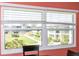 Scenic view from the window featuring lush greenery, manicured lawns, and nearby buildings at 4726 Marine Pkwy # 201, New Port Richey, FL 34652