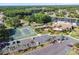 Aerial view of community amenities with tennis courts, swimming pool, and parking for a vibrant lifestyle at 4837 Prince George Cir, New Port Richey, FL 34655