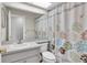 Clean bathroom with a large mirror and floral-patterned shower curtain creating a refreshing space at 4837 Prince George Cir, New Port Richey, FL 34655