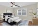 Comfortable bedroom boasts a ceiling fan, natural light from the window, and contemporary décor at 4837 Prince George Cir, New Port Richey, FL 34655