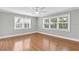 Spacious bedroom with hardwood floors, neutral paint, and a ceiling fan at 4837 Prince George Cir, New Port Richey, FL 34655