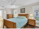 Comfortable bedroom with hardwood floors, ceiling fan, and bright windows at 4837 Prince George Cir, New Port Richey, FL 34655