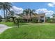 Well-maintained clubhouse with lush green lawn, mature trees, and manicured landscaping at 4837 Prince George Cir, New Port Richey, FL 34655
