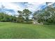 Expansive green space with a scenic lake and wooden docks, offering a peaceful and inviting community atmosphere at 4837 Prince George Cir, New Port Richey, FL 34655