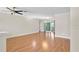 Bright living room with wood floors and sliding glass doors to the outside at 4837 Prince George Cir, New Port Richey, FL 34655