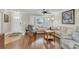 Inviting living room featuring hardwood floors, a large bay window, and a cozy rocking chair at 4837 Prince George Cir, New Port Richey, FL 34655