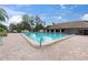 Large community pool with ample seating and shade, perfect for relaxation and recreation at 4837 Prince George Cir, New Port Richey, FL 34655
