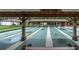 Outdoor shuffleboard courts offer a recreational space for residents, complemented by shaded viewing areas at 4837 Prince George Cir, New Port Richey, FL 34655