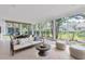 Sunroom with tiled floors, backyard view, and sofa at 4837 Prince George Cir, New Port Richey, FL 34655