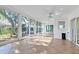 Bright sunroom with tiled floors and large sliding glass doors with yard views at 4837 Prince George Cir, New Port Richey, FL 34655