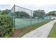 Outdoor tennis courts offer an athletic outlet, surrounded by lush landscaping and secure fencing at 4837 Prince George Cir, New Port Richey, FL 34655