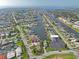 An aerial view of a waterfront community featuring a well-maintained property with lush green lawns and ample parking space at 5106 Blue Heron Dr, New Port Richey, FL 34652