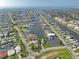 Panoramic aerial view of a waterfront community with canal access, docks, and lush landscaping in a coastal setting at 5106 Blue Heron Dr, New Port Richey, FL 34652
