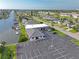 An aerial view of a well-maintained property with waterfront access, lush landscaping, and ample parking at 5106 Blue Heron Dr, New Port Richey, FL 34652