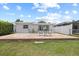 An inviting backyard with a patio and a table and chair set for relaxing and entertaining outdoors at 5106 Blue Heron Dr, New Port Richey, FL 34652