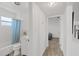 Bright bathroom with bathtub, vanity, and tile, located near a bedroom at 5106 Blue Heron Dr, New Port Richey, FL 34652
